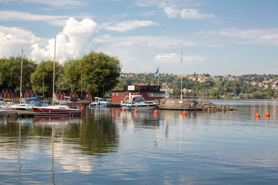 Boats at lake against sky