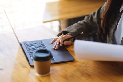 Midsection of woman using calculator