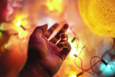 Close-up of hand holding burning leaf