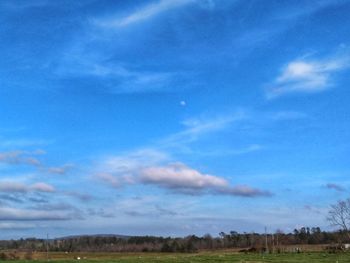 Scenic view of landscape against blue sky