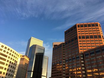 Low angle view of modern buildings against sky in city