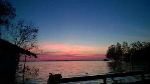 Scenic view of lake against orange sky