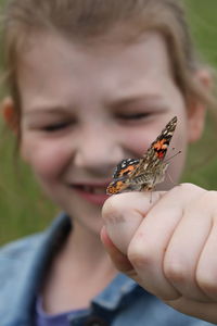 Close-up of butterfly on hand