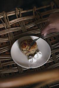 Midsection of person having food in plate on table