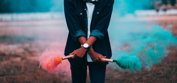 Full length of man holding umbrella