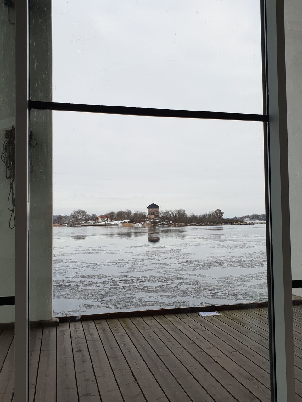 REAR VIEW OF PERSON LOOKING THROUGH WINDOW