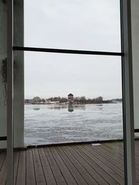 Rear view of man looking through window