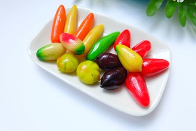 High angle view of multi colored candies on plate