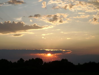 Scenic view of silhouette trees against sky during sunset