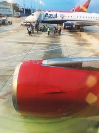 Close-up of airplane on airport runway against sky