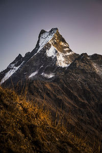 Scenic view of snowcapped mountains against clear sky