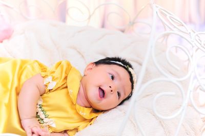 Close-up portrait of a baby girl sleeping on bed