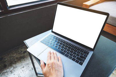 Cropped hands using laptop on table