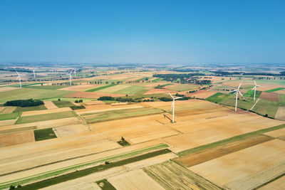 Windmill turbine in the field at summer day. rotating wind generator