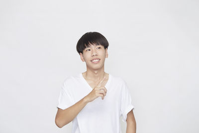 Portrait of smiling man standing against white background