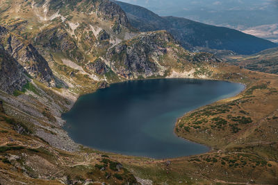 High angle view of lake amidst mountains against sky