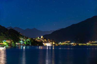 Scenic view of lake against sky at night