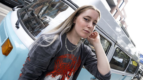 Portrait of young woman sitting in car