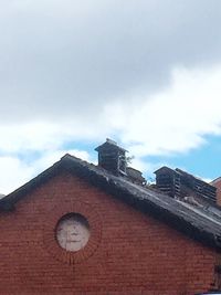 Low angle view of building against cloudy sky