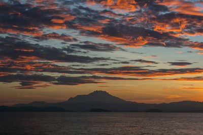 A silhoutte of mount kinabalu in sabah during sunrise with burning sky