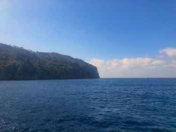 Scenic view of sea against blue sky