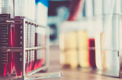 Colorful chemicals in laboratory glassware on table