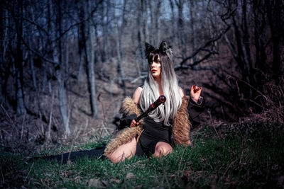 Rear view of woman standing in forest