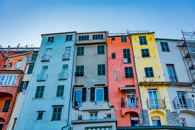 Low angle view of multi colored buildings against clear sky