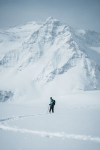 Man on skis enjoying the view at winter wonderland in the austrian alps