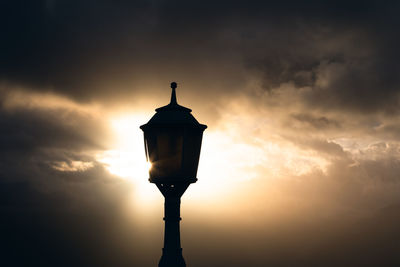 Low angle view of street light against sky during sunset