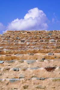 Low angle view of stone wall against sky