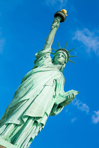 Low angle view of statue against blue sky