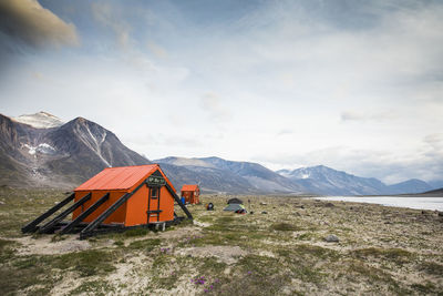 Built structure on snowcapped mountain against sky