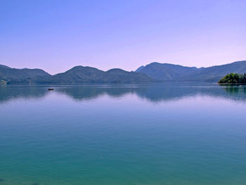 Scenic view of lake against clear blue sky
