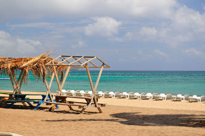 Lifeguard hut on beach against sky