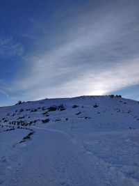 Scenic view of snow covered mountain against sky