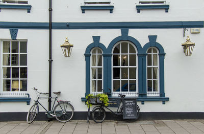 Bicycle parked on street against building