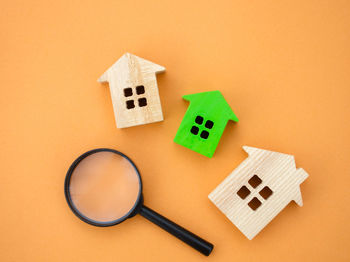 Magnifying glass and wooden houses. house searching concept. home appraisal.