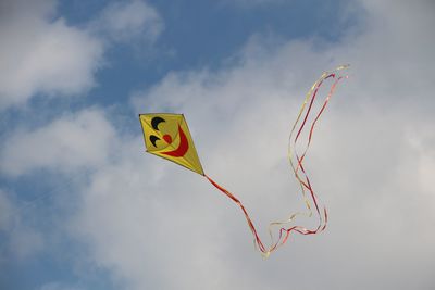 Low angle view of kite flying against sky