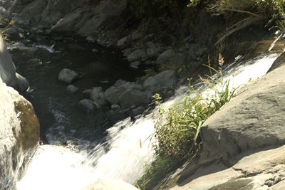 High angle view of waterfall amidst rocks