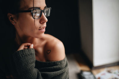 Portrait of young woman with eyeglasses looking away