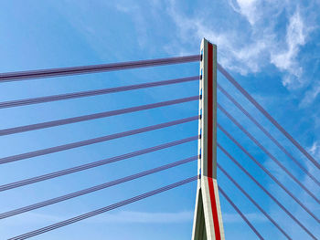 Low angle view of suspension bridge against sky