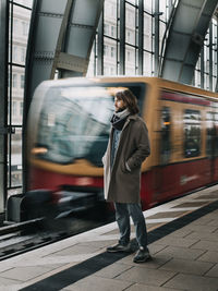 Rear view of man standing in train