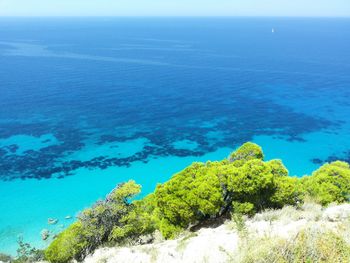 High angle view of sea against clear blue sky