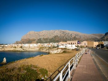 Scenic view of town against clear blue sky