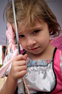 Close-up portrait of bored girl holding umbrella