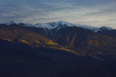 Dolomites mountains with snow and sunset sky