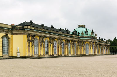 Low angle view of historical building against cloudy sky