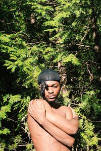 Thoughtful man standing by tree