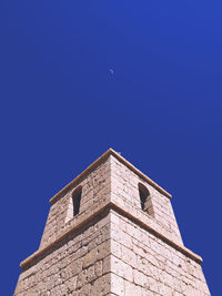 Low angle view of building against blue sky